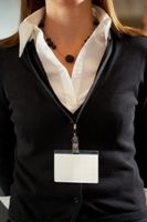 Photo of a young woman labeled with a blank name tag.