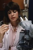 Woman studying microscope slide
